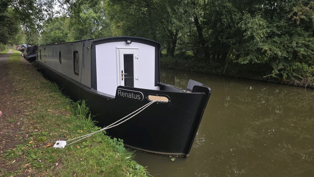 Renatus - the prototype boat that fuelled the vision A narrowboat with a black hull and white cabin sides.